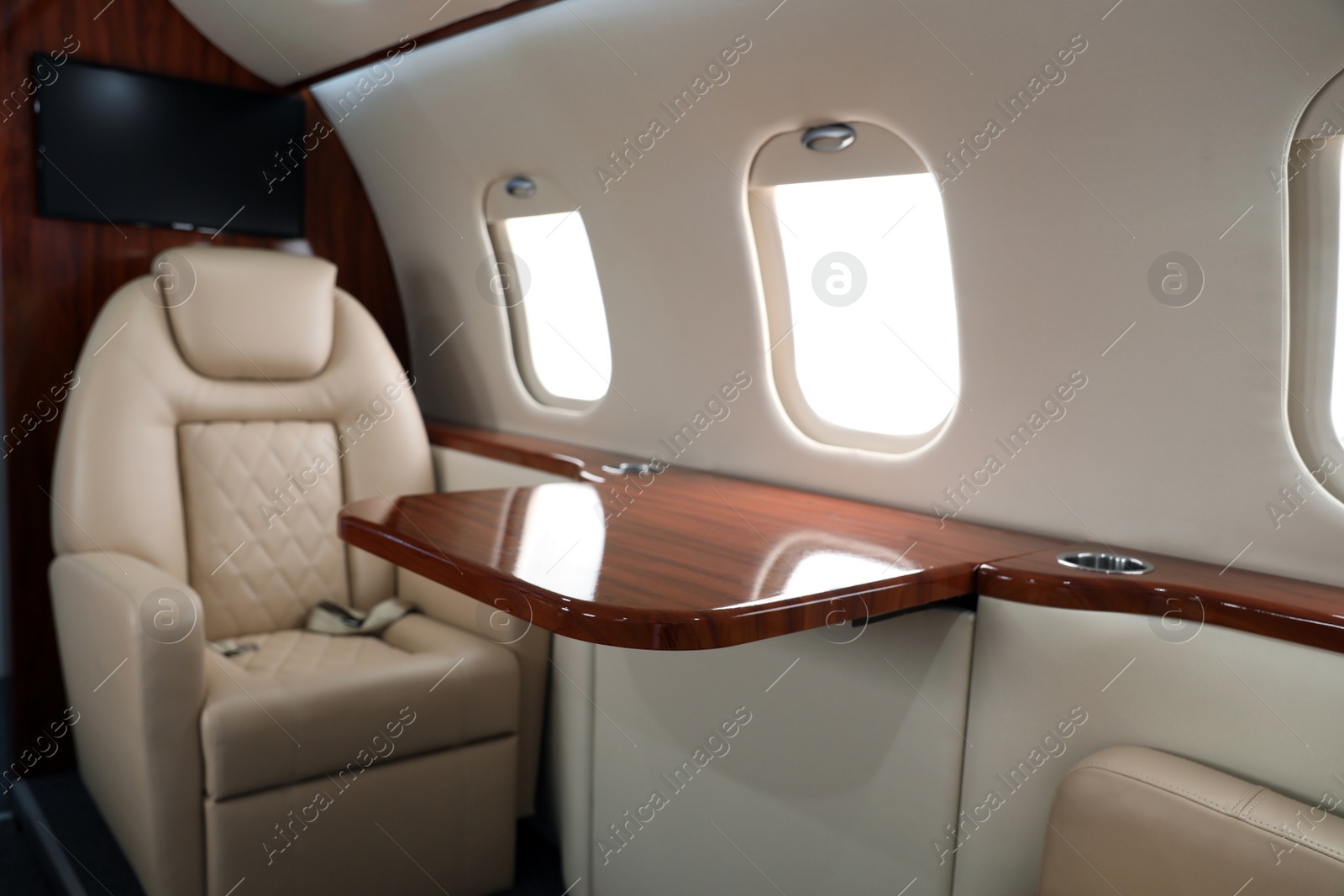 Image of Airplane cabin with comfortable seat and table