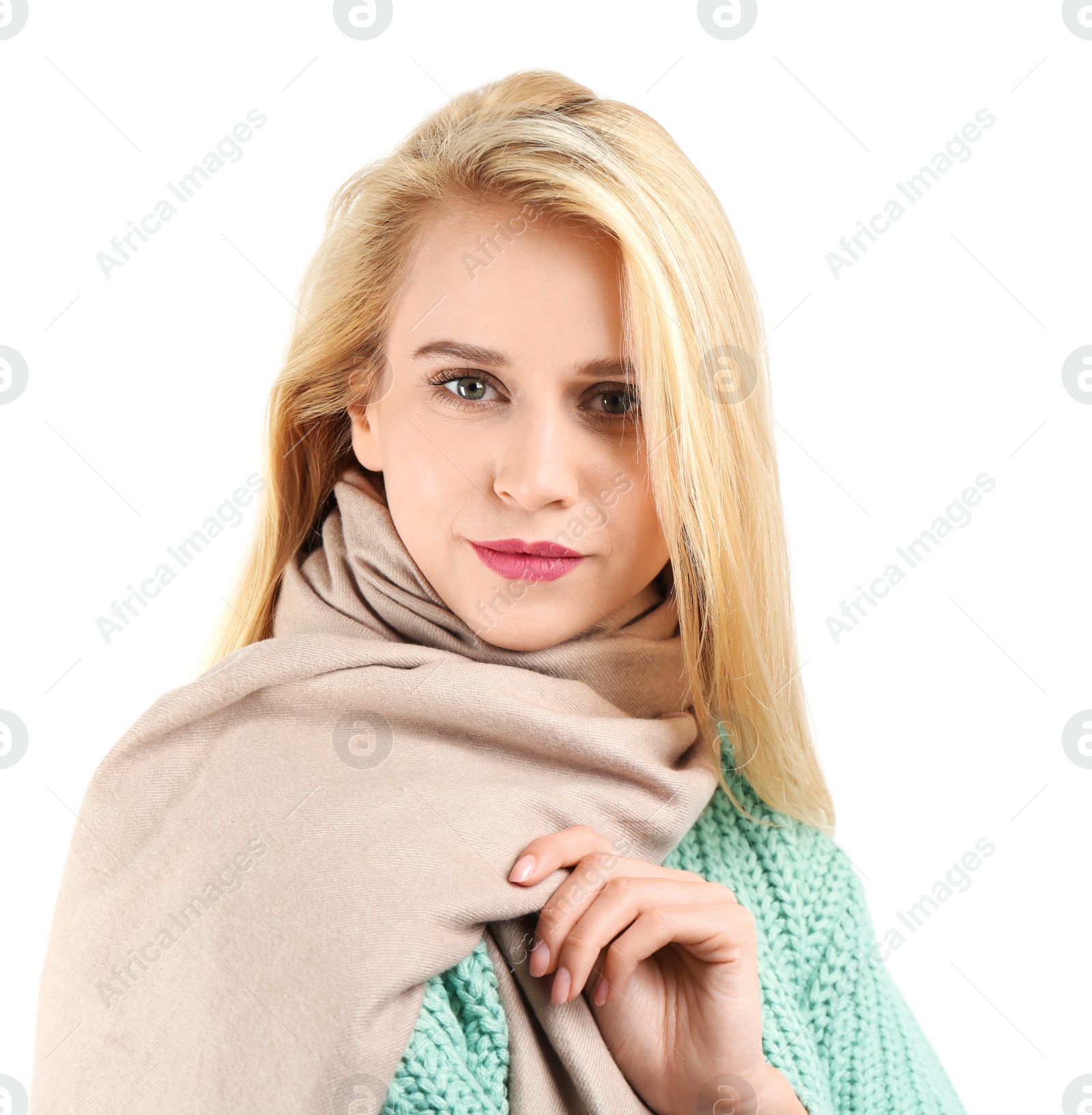 Image of Pretty young woman wearing warm sweater and scarf on white background