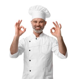 Photo of Happy chef in uniform showing OK gesture on white background