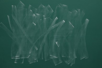 Photo of Dirty green chalkboard as background. School equipment