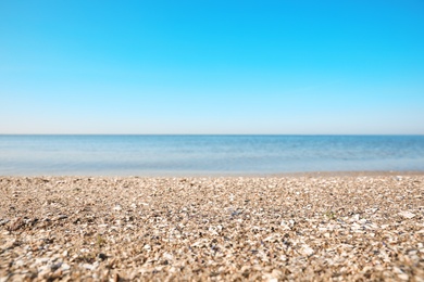 Beautiful view of sandy beach and sea on sunny summer day