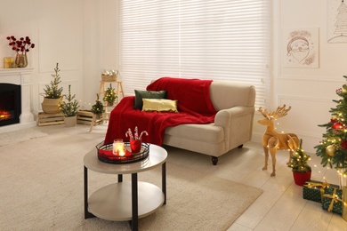 Living room with fireplace and Christmas decorations. Festive interior design