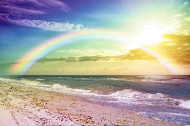 Image of Beautiful view of colorful rainbow in sky over sea