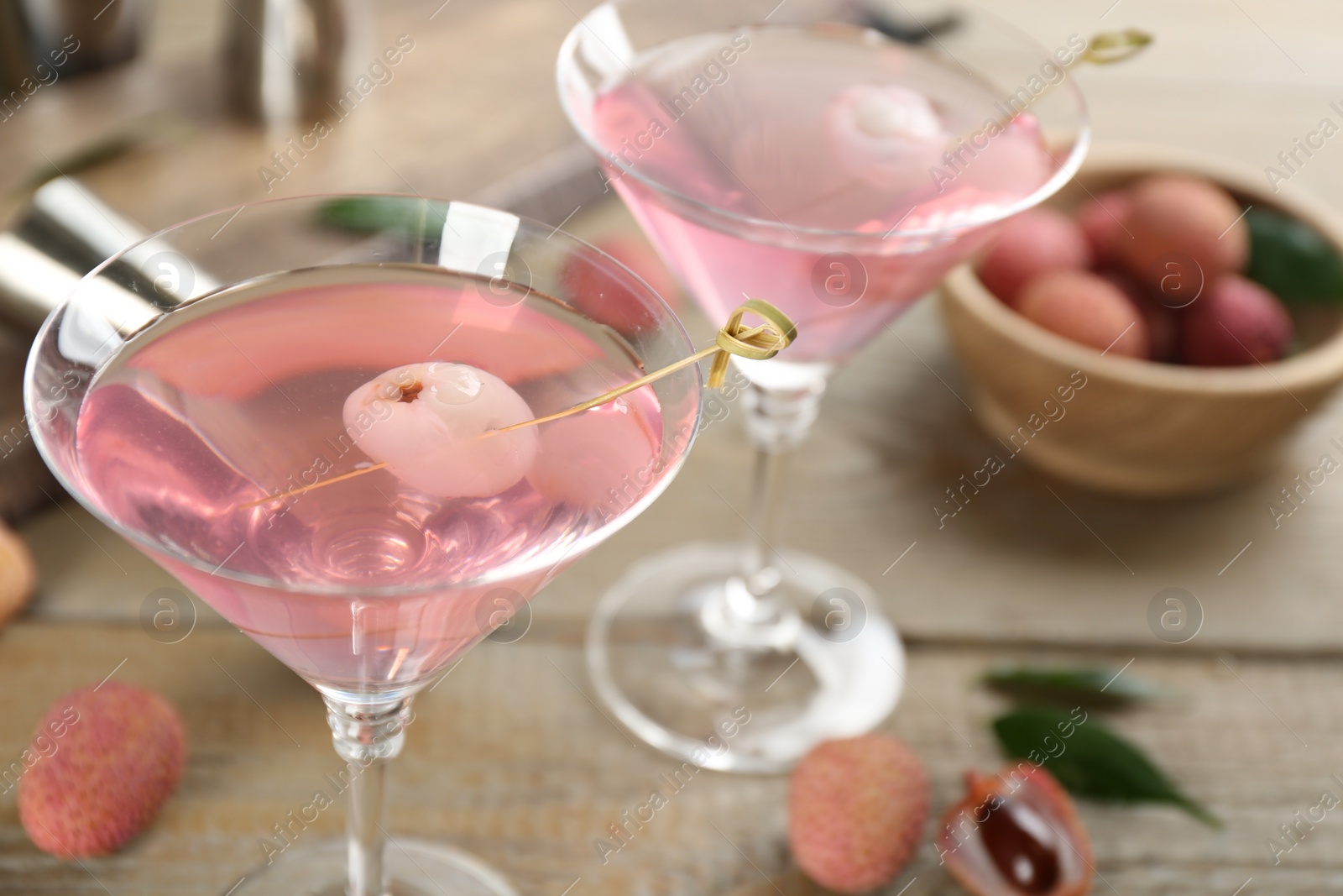 Photo of Delicious lychee cocktails on wooden table, closeup