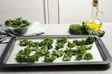 Photo of Raw cabbage leaves on grey table. Preparing kale chips