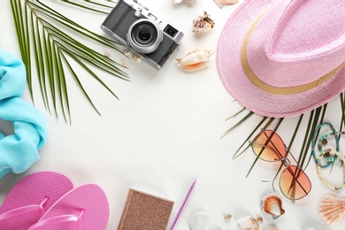 Photo of Flat lay composition with stylish hat, camera and beach objects on white background