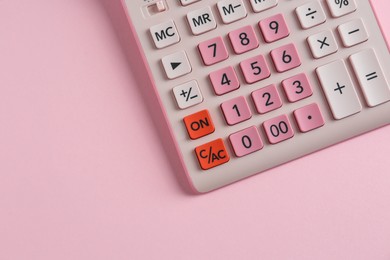 Modern calculator on pink background, top view. Space for text