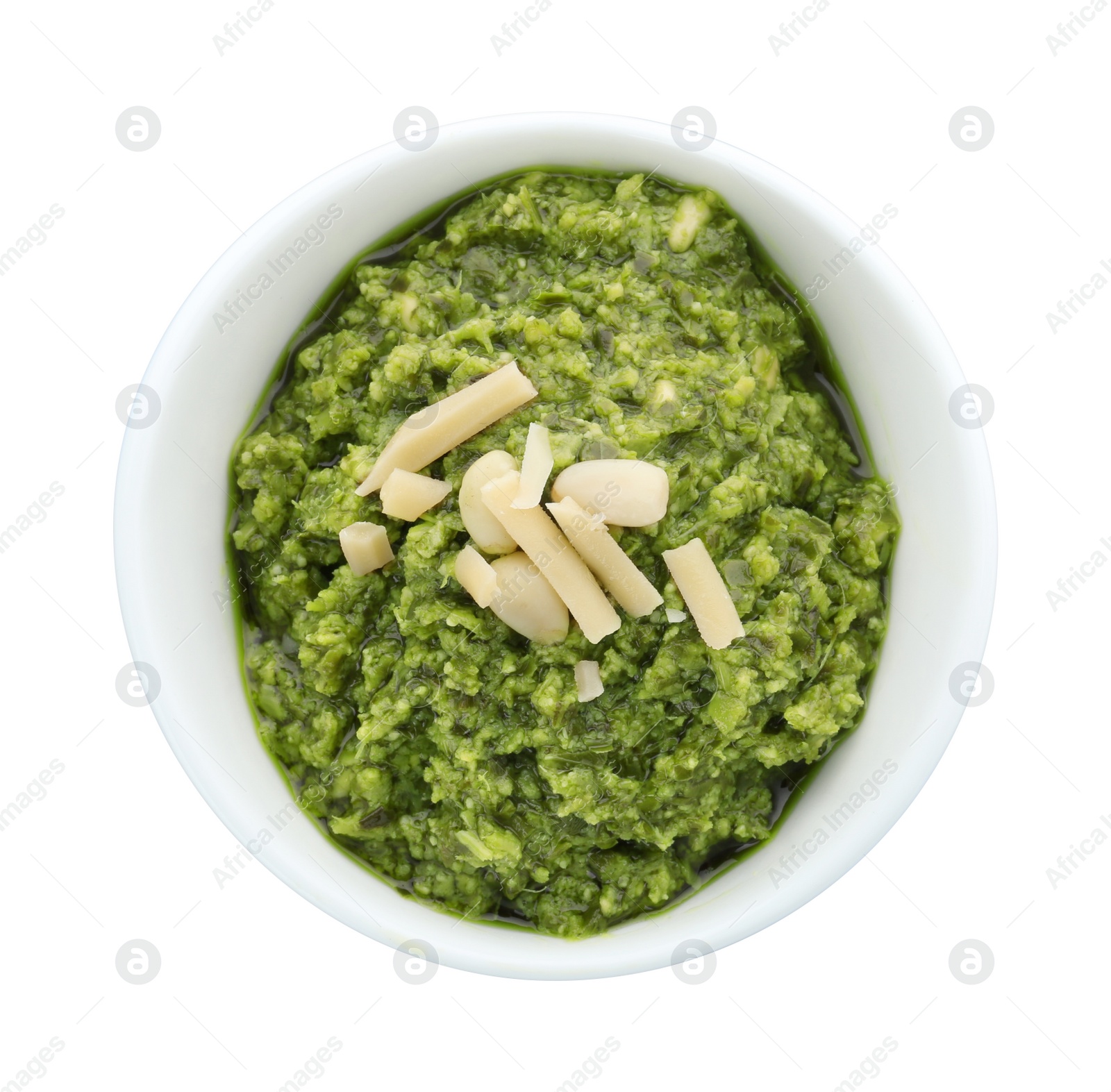 Photo of Bowl of tasty pesto sauce isolated on white, top view