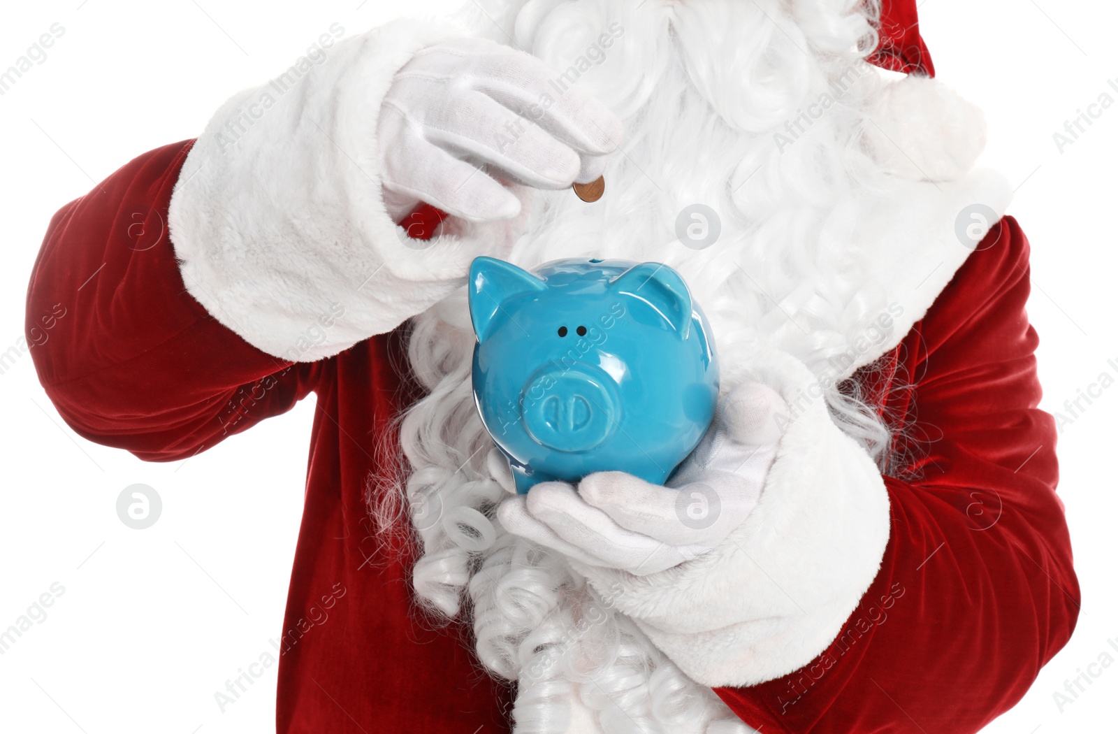 Photo of Santa Claus putting coin into piggy bank on white background, closeup