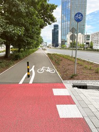 Bicycle lane with white sign painted on asphalt