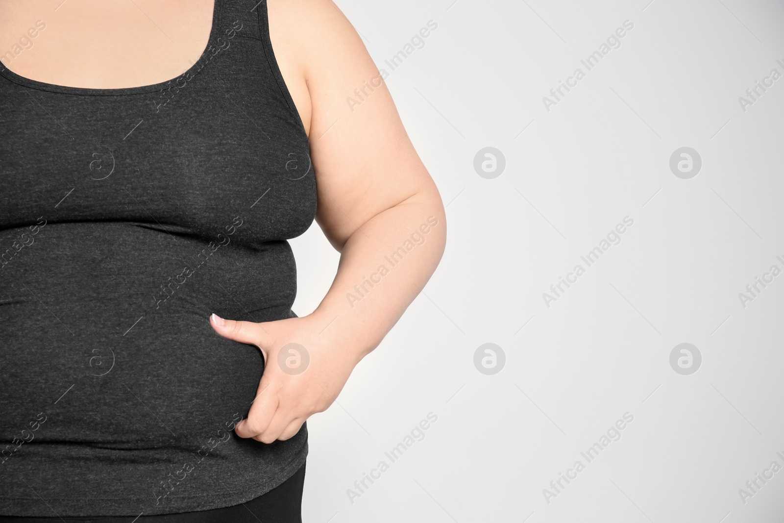 Photo of Overweight woman on light background