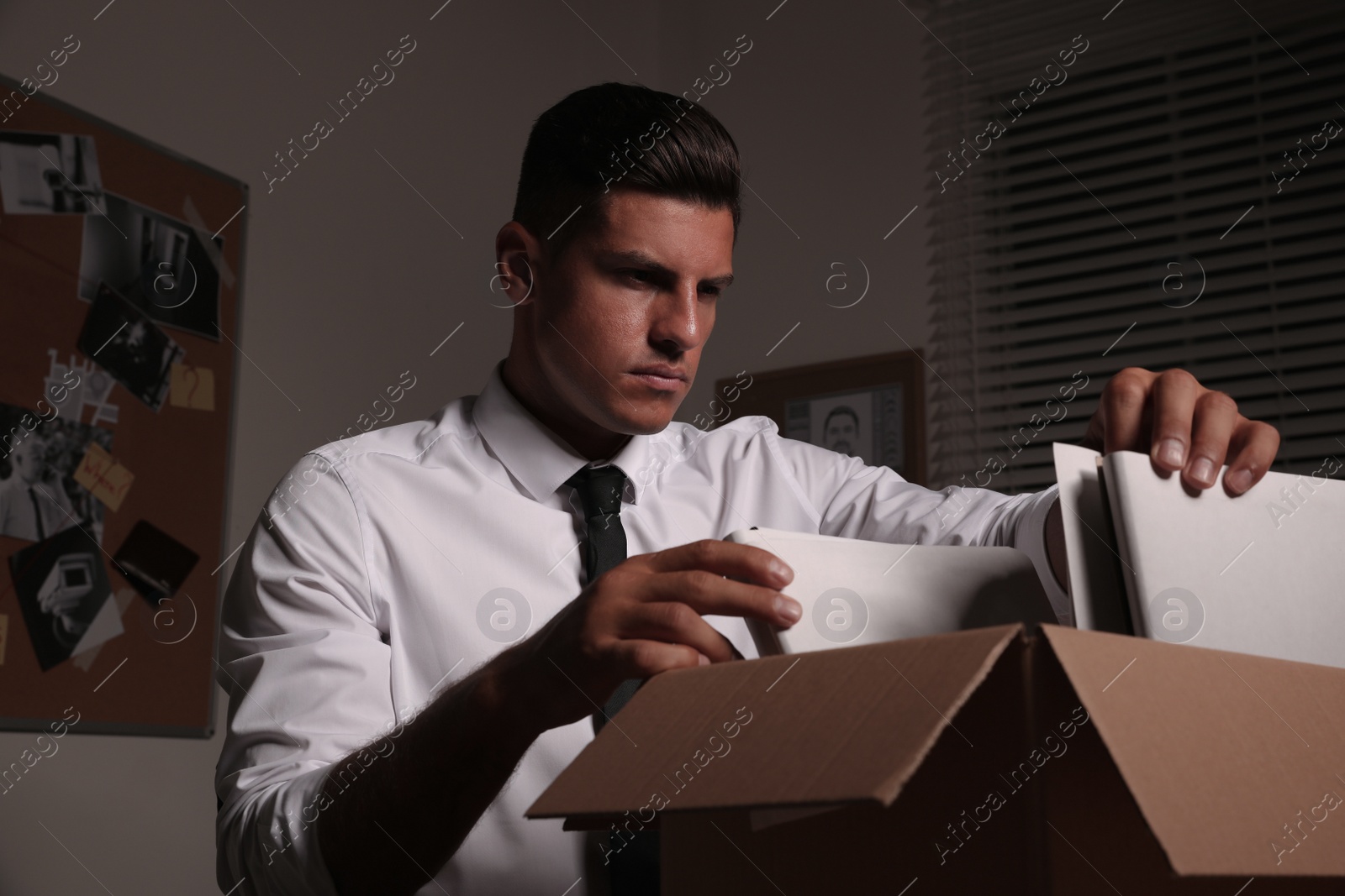 Photo of Professional detective doing paperwork in his office