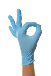 Photo of Person in blue latex gloves showing okay gesture against white background, closeup on hand