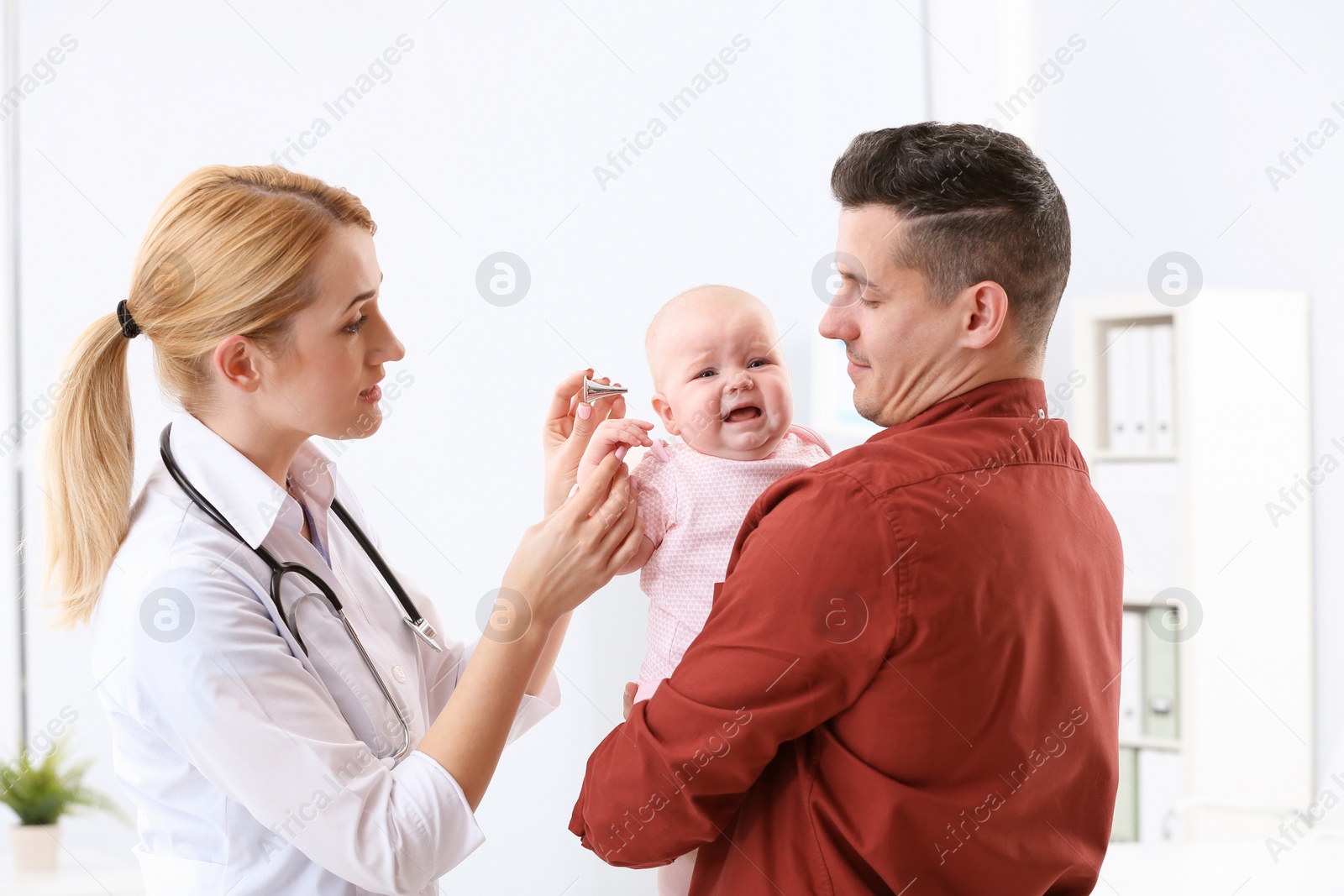 Photo of Man with his baby visiting children's doctor in hospital