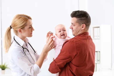 Man with his baby visiting children's doctor in hospital