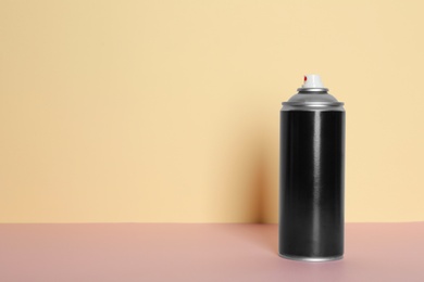 Photo of Can of spray paint on color background. Space for text