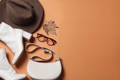 Flat lay composition with stylish hat on orange background, space for text