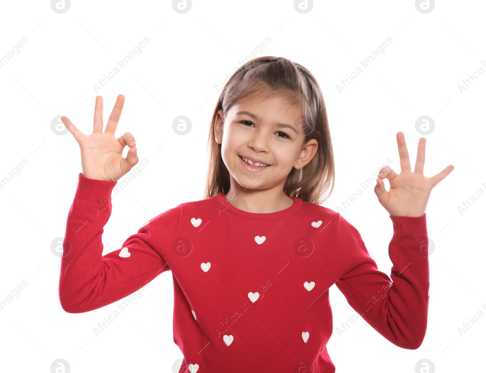 Photo of Little girl showing OK gesture in sign language on white background