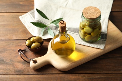 Composition with fresh olive oil on table