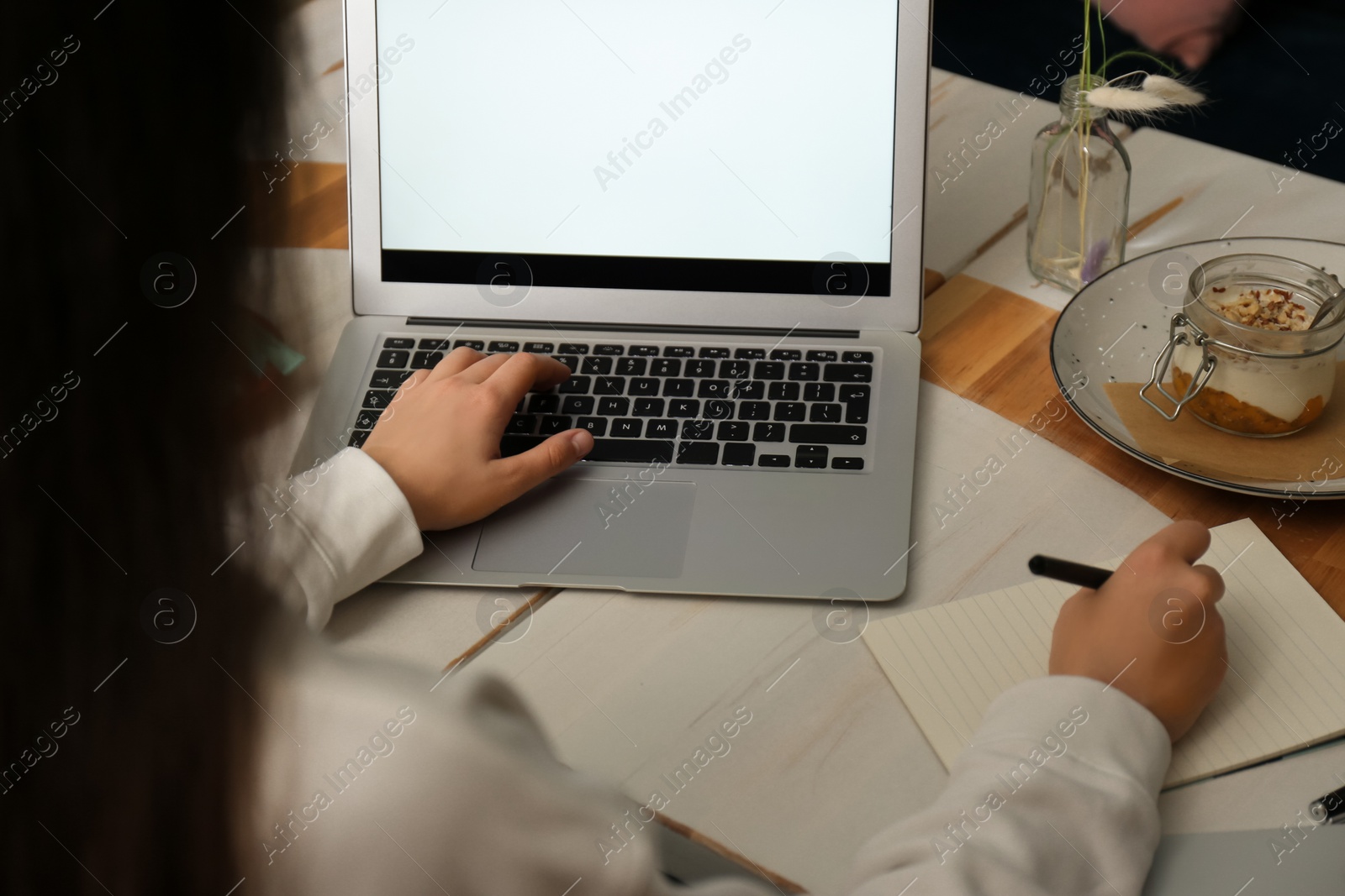 Photo of Blogger working with laptop in cafe, closeup