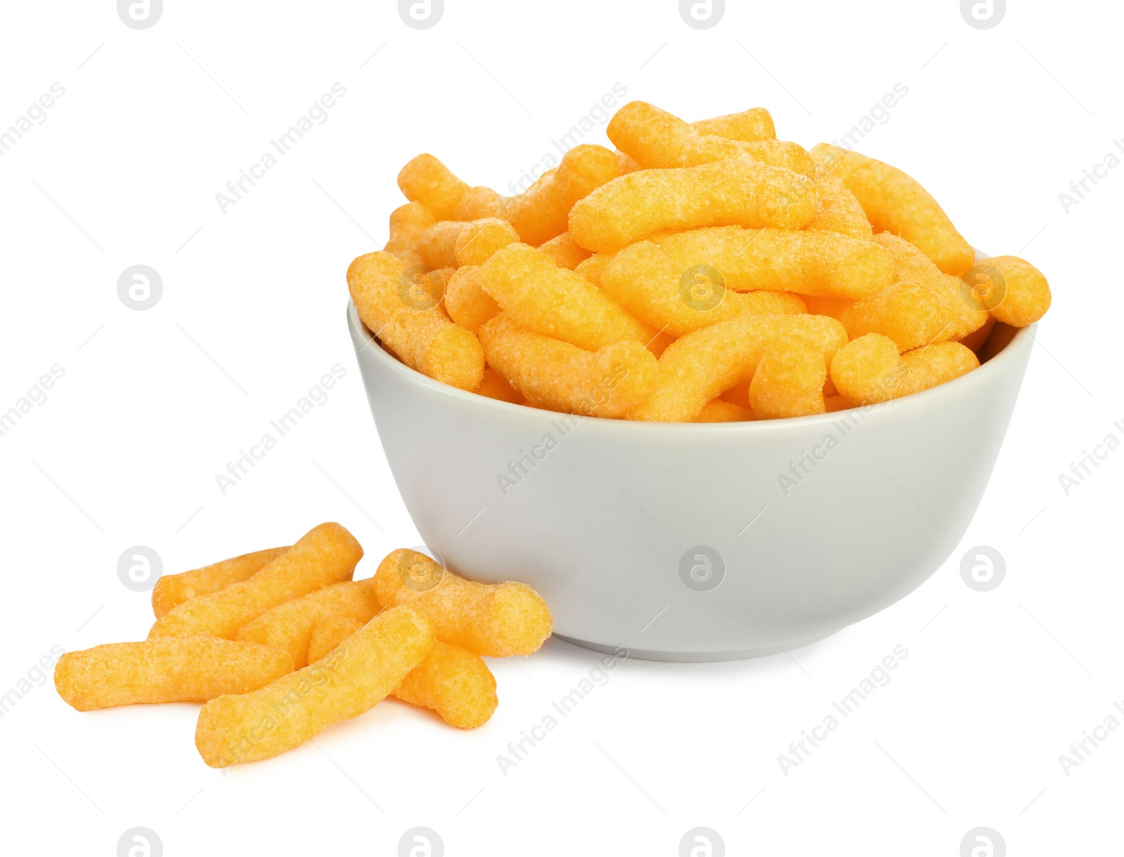 Photo of Many tasty cheesy corn puffs in bowl isolated on white