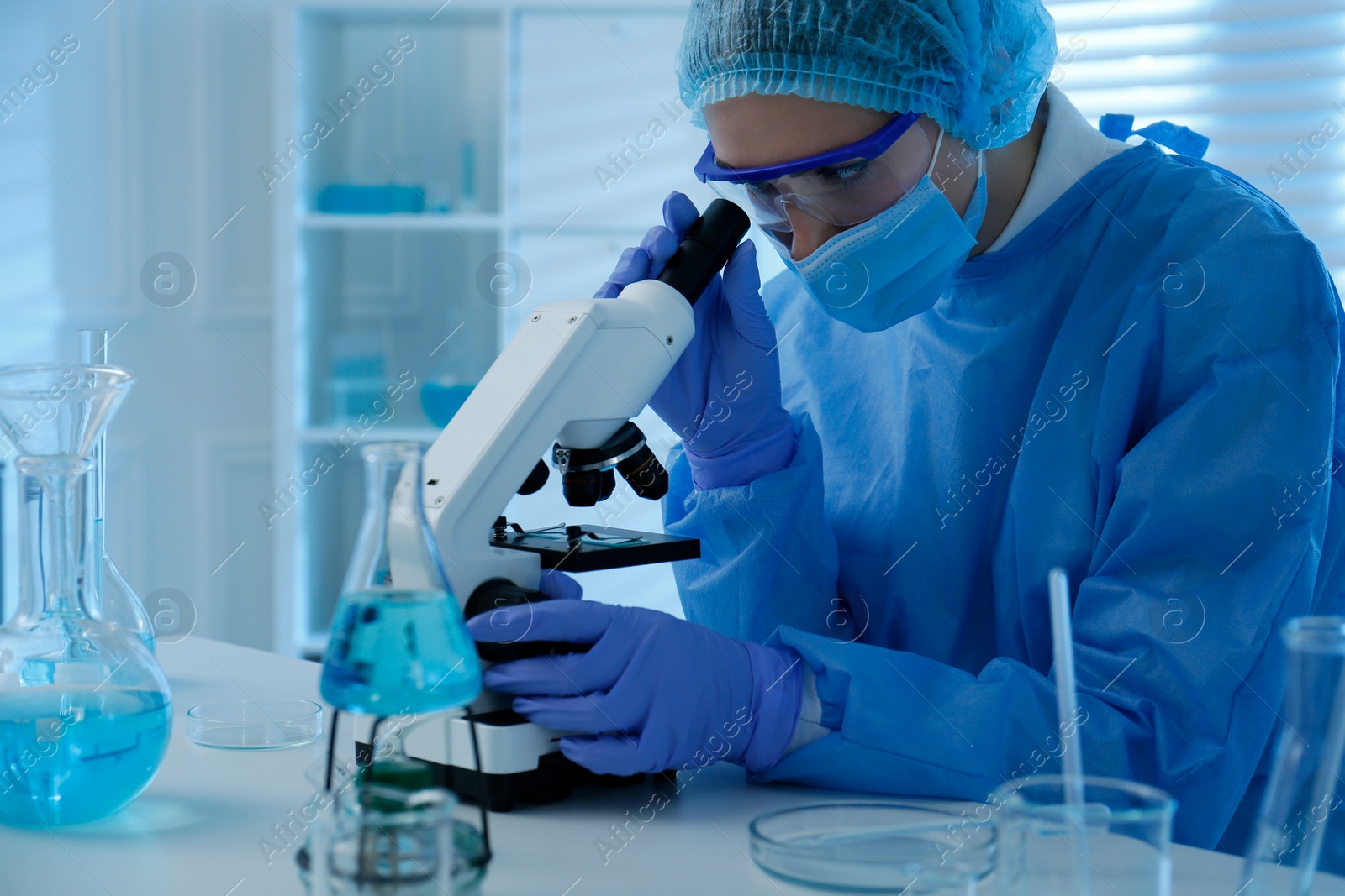 Photo of Scientist working with microscope in laboratory. Medical research