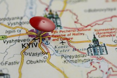 Photo of MYKOLAIV, UKRAINE - NOVEMBER 09, 2020: Kyiv city marked with push pin on map of Ukraine, closeup