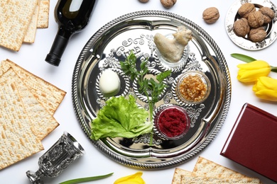 Photo of Flat lay composition with symbolic Passover (Pesach) items and meal on color background