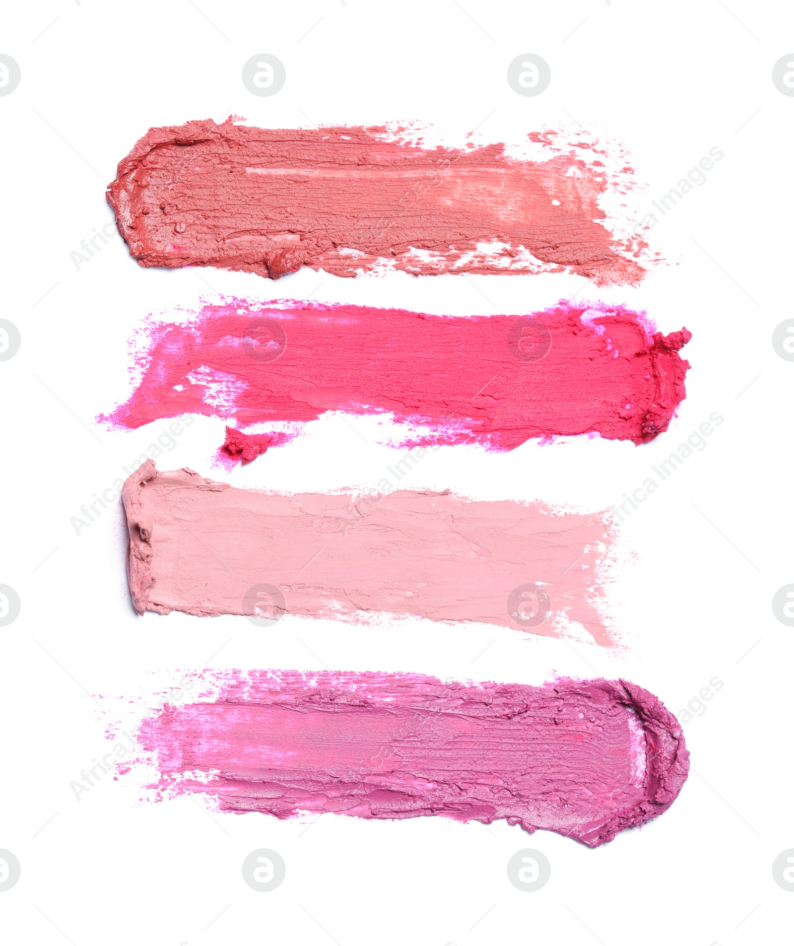 Photo of Smears of different beautiful lipsticks on white background, top view