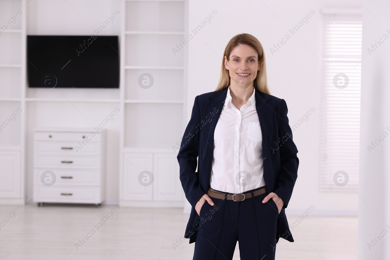 Photo of Happy real estate agent in new apartment. Space for text