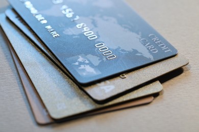 Many credit cards on gray background, closeup