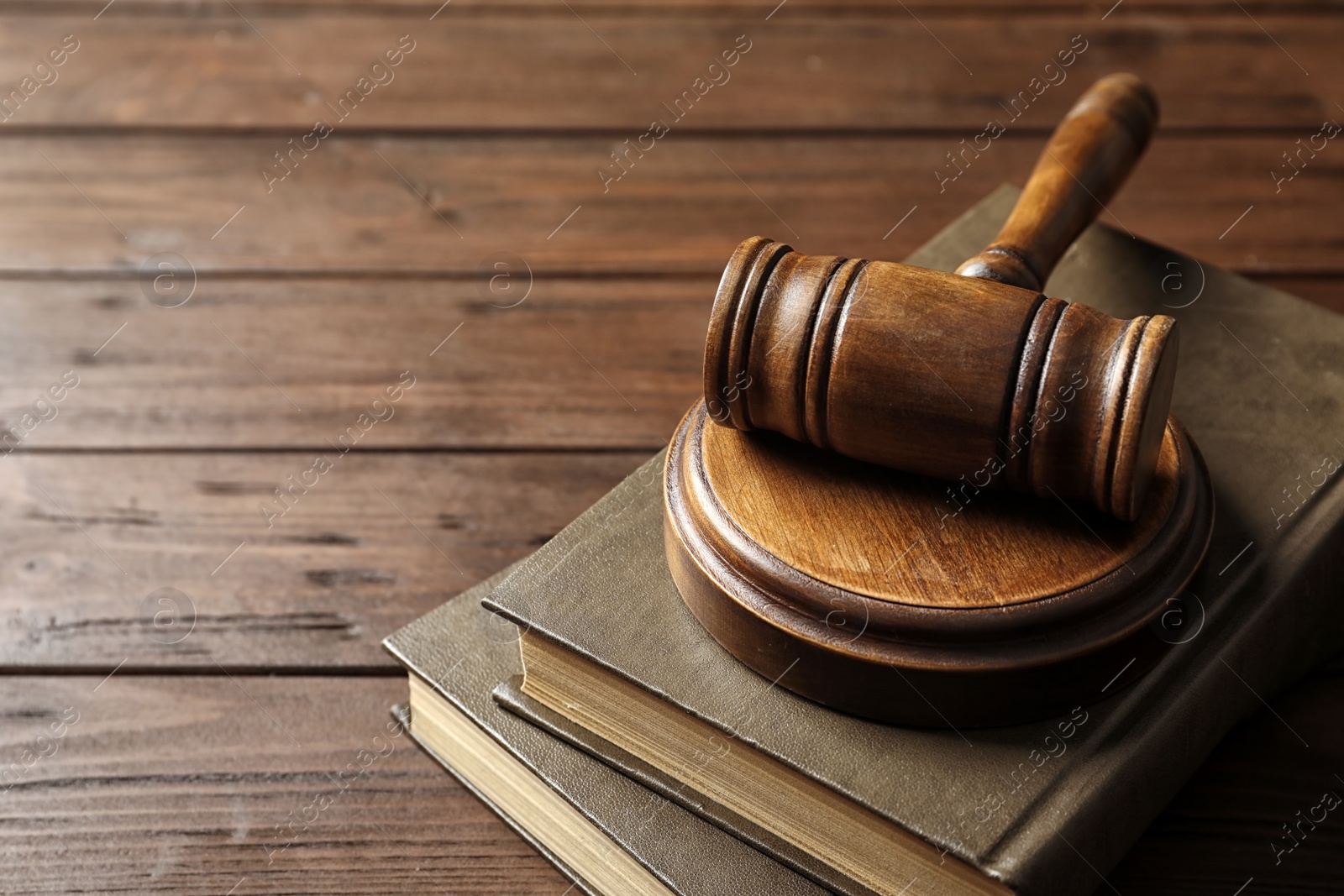 Photo of Judge gavel and books on wooden background. Law concept