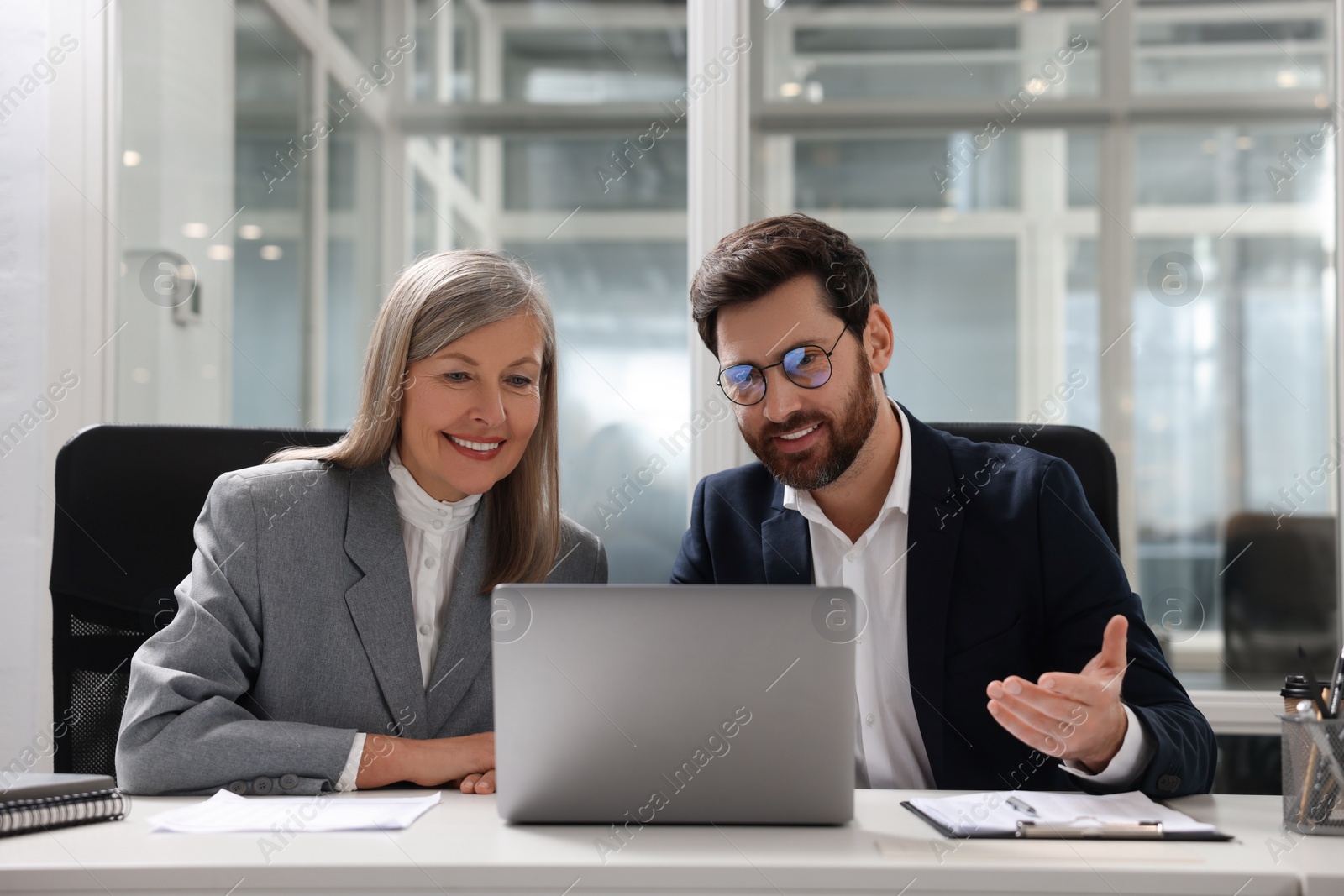 Photo of Lawyers working together at table in office