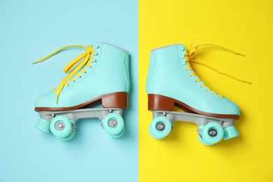 Photo of Vintage roller skates on color background, top view