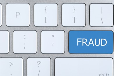 Image of Blue button with word FRAUD on keyboard, top view