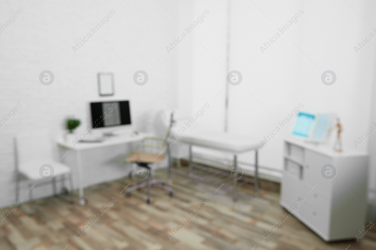 Photo of Blurred view of modern medical office. Doctor's workplace