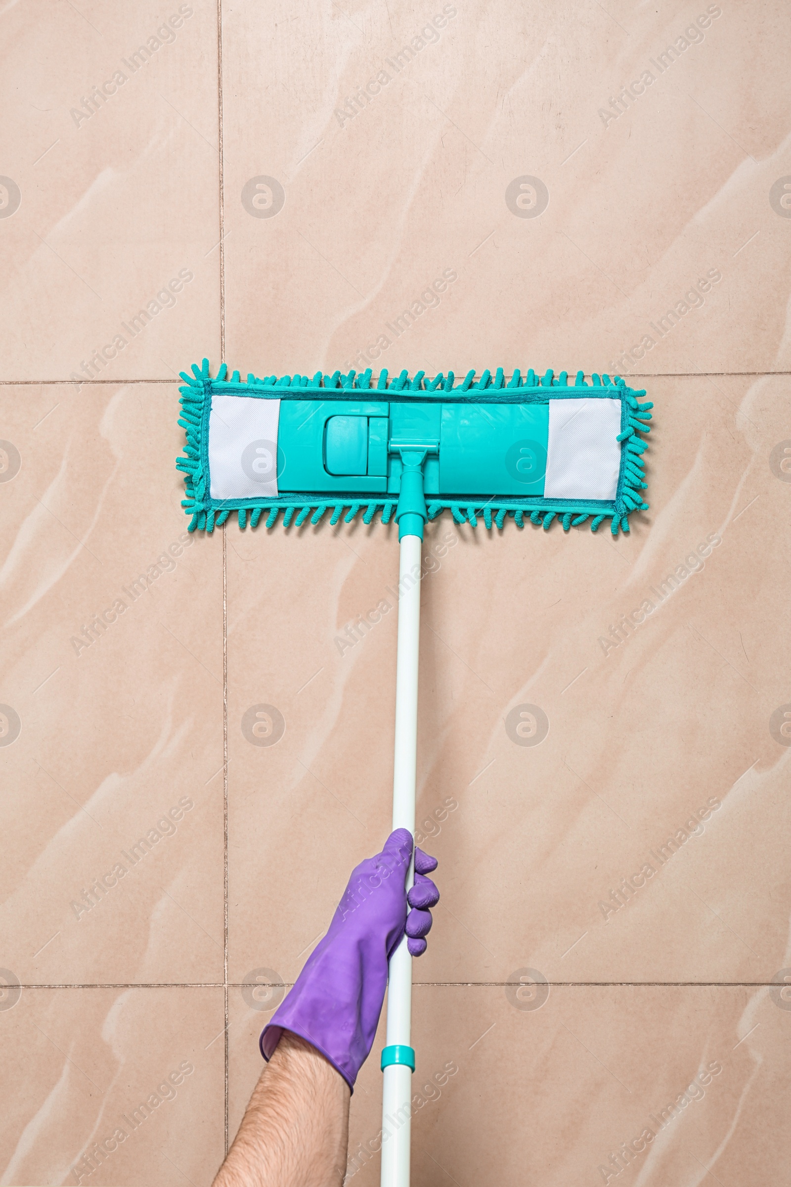 Photo of Man cleaning floor with mop, top view