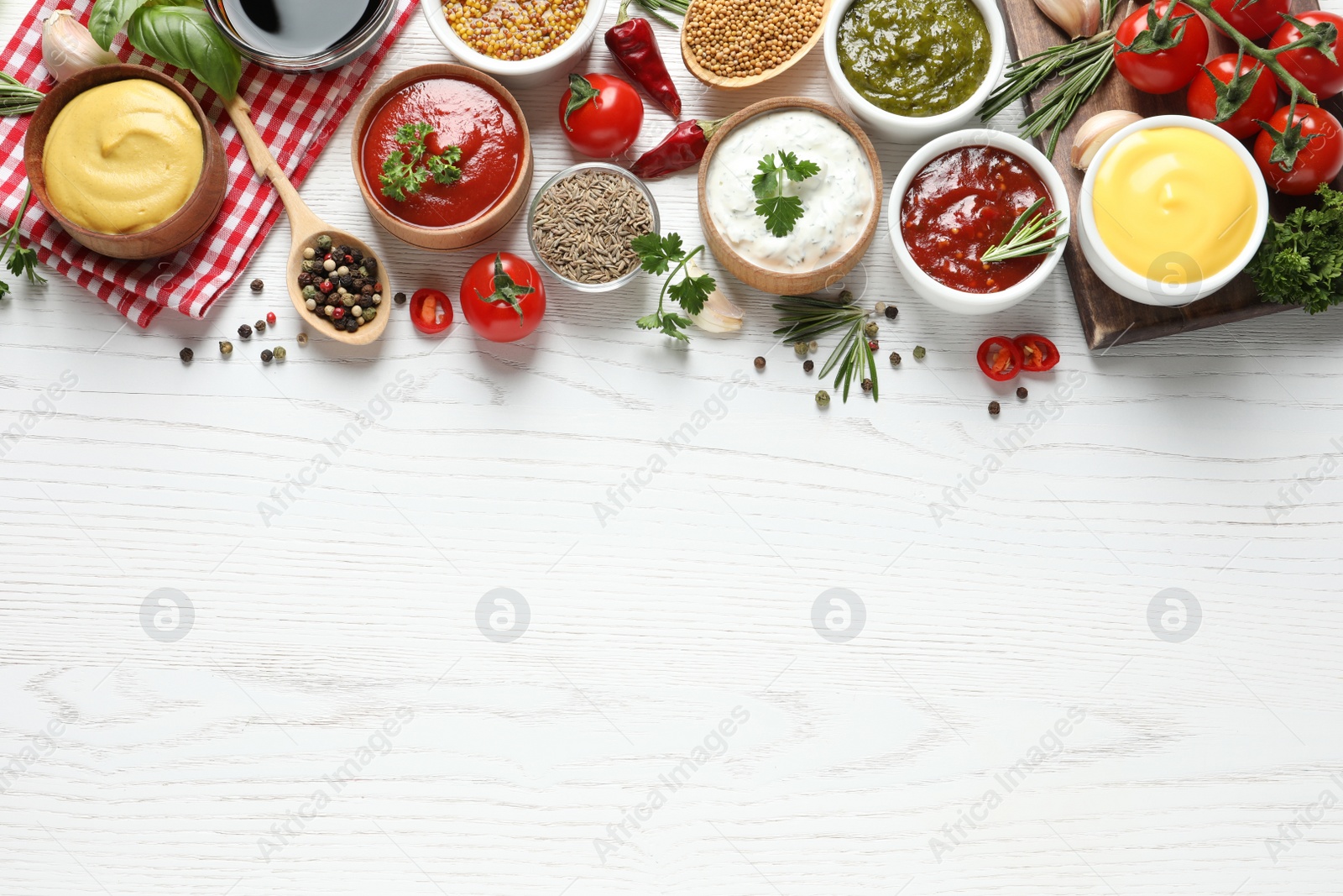 Photo of Flat lay composition with different sauces and space for text on white wooden background