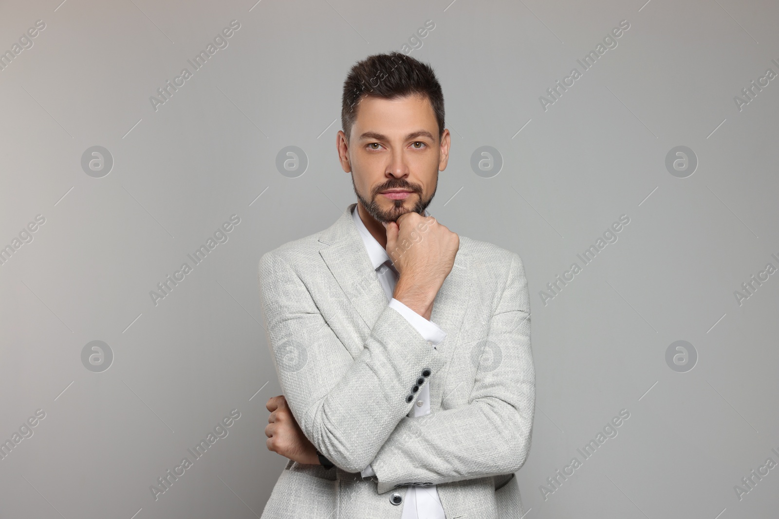 Photo of Teacher in light suit against beige background