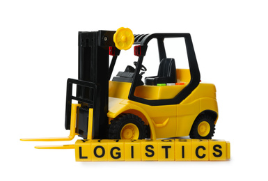 Photo of Toy forklift and cubes with word LOGISTICS isolated on white. Wholesale concept