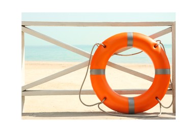 Paper photo. Orange lifebuoy near wooden railing on beach 