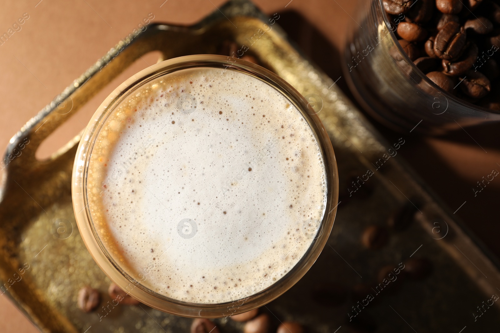 Photo of Aromatic coffee with milk in glass on table, top view