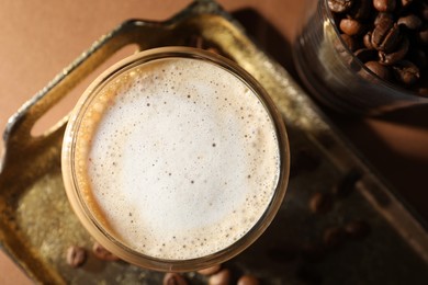 Photo of Aromatic coffee with milk in glass on table, top view