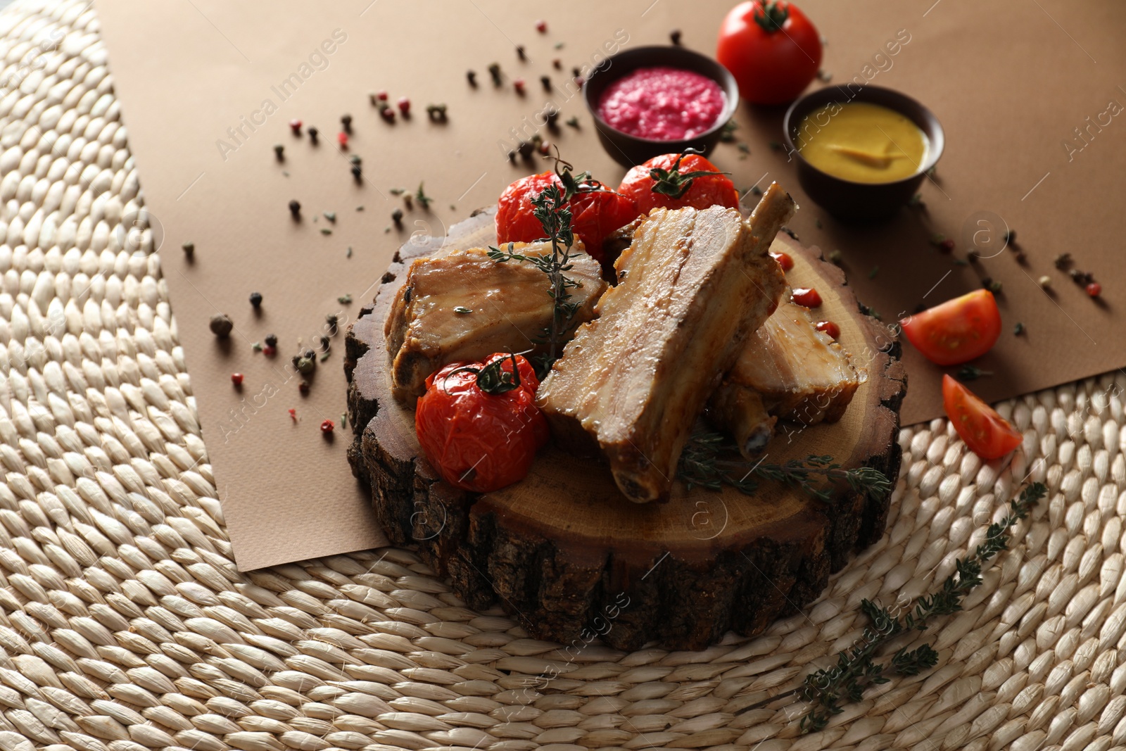 Photo of Delicious roasted ribs with tomatoes served on table