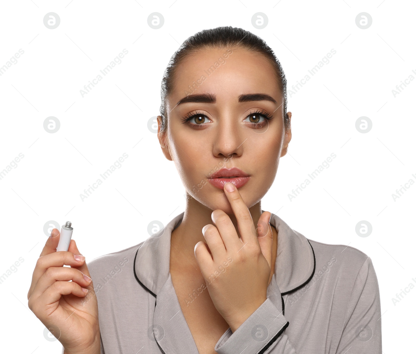 Photo of Woman with herpes applying cream on lips against white background