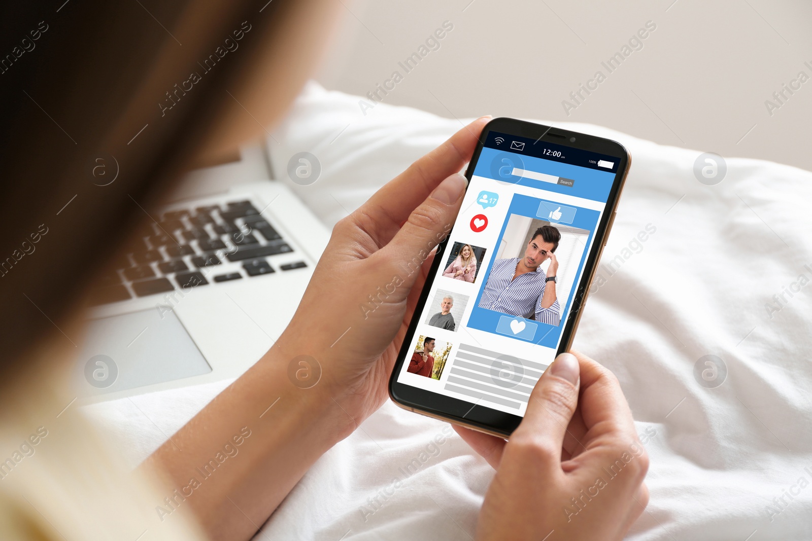 Image of Young woman visiting online dating site via smartphone indoors, closeup