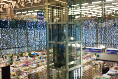 Photo of Blurred view of shopping mall interior decorated for Christmas. Bokeh effect