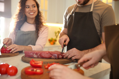 People cooking food together in kitchen, closeup