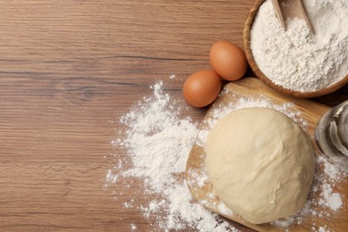 Cooking scones with soda water. Dough and ingredients on wooden table, flat lay. Space for text