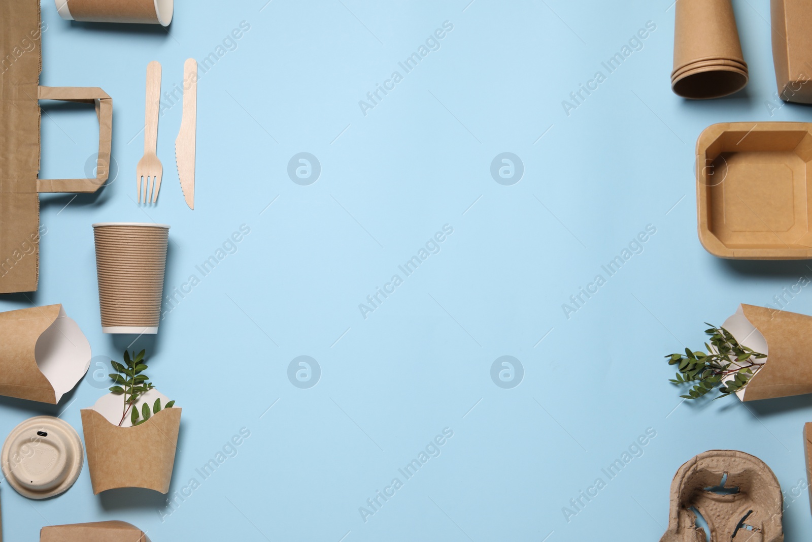 Photo of Flat lay composition with eco friendly food packagings and twigs on light blue background. Space for text